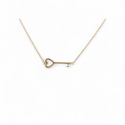 18KT YELLOW GOLD TIFFANY & CO EAST-WEST HEART KEY PENDANT NECKLACE.