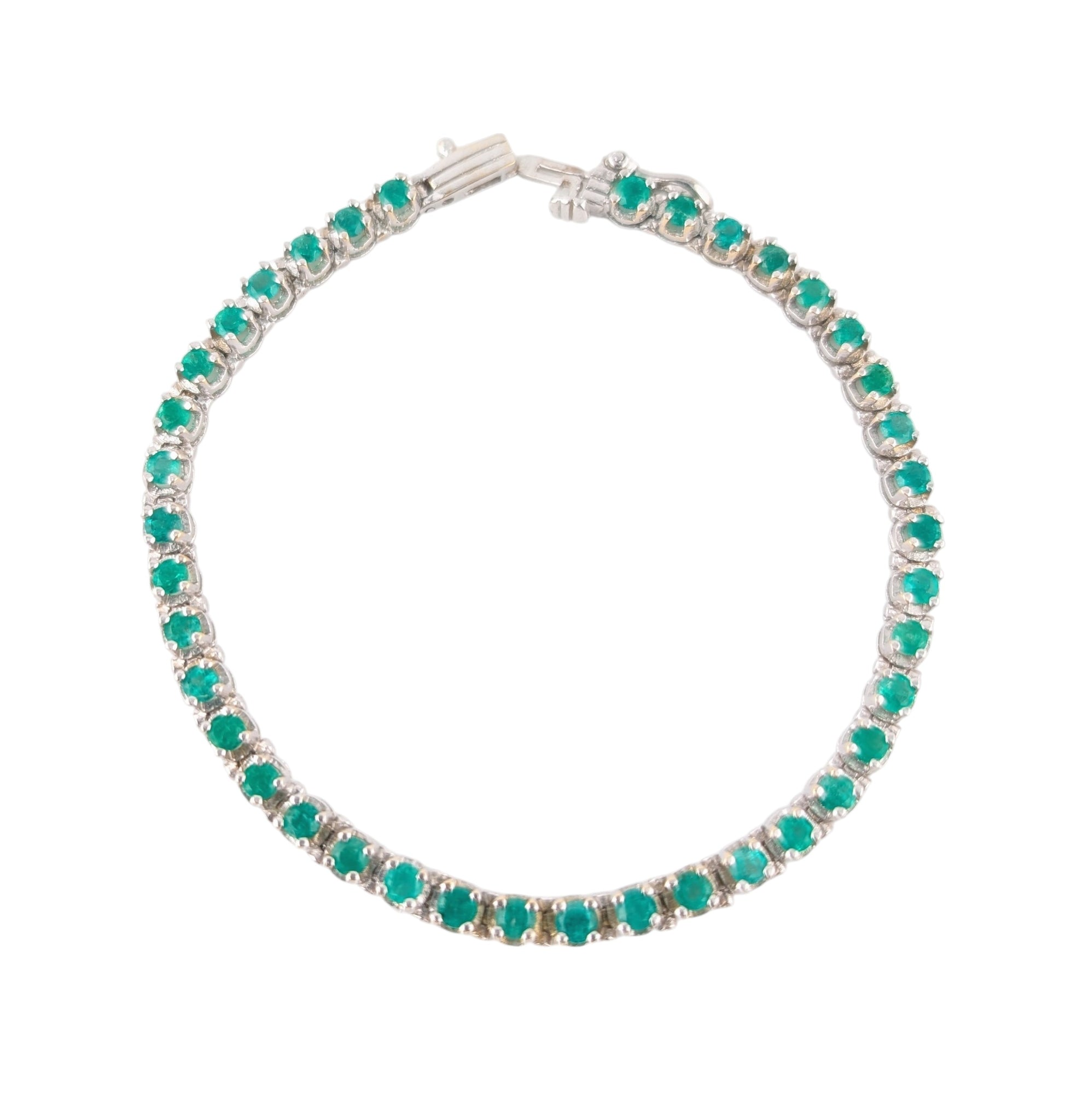14KT WHITE GOLD PRONG SET EMERALD BRACELET.
